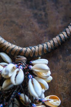 This African Tribal Cowrie Shell Necklace Pendant is a unique and timeless piece of jewelry crafted from an old Tribal Cowrie Shell pendant, leather necklace, and Venetian Chevron Trade Beads. Carefully handcrafted to last for years of enjoyment, it's a great way to show off your tribal culture in style. Length: 15 inches Traditional Leather Jewelry For Gifts, Traditional Leather Jewelry As Gift, Unique Brown Jewelry For Ceremonial Occasions, Traditional Leather Jewelry For Festival, Ceremonial Handmade Adjustable Necklace, Artisan Adjustable Necklace For Ceremonial Use, Artisan Adjustable Necklace For Ceremonial Occasions, Traditional Adjustable Leather Jewelry, Handmade Brown Necklaces For Rituals