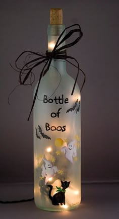 a bottle that has some lights in it and is lit up with the words bottle of boos