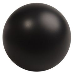 a black ball sitting on top of a white surface