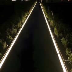 a long path with lights on it in the dark