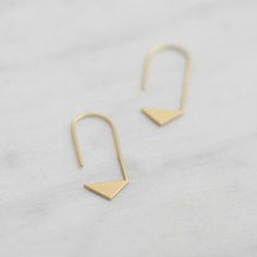 . Trendy . Minimal . Unique . Inspired by geometry, These triangle thread earrings are comfortable to wear everyday adding a modern touch to your casual look. Also the best gift for girls who loves design!  :: Material > sterling silver / yellow gold filled=sterling silver coated with 5 micrometers thick of 22k yellow gold.  :: Finish > matte  :: Approx. Measurements > Height 38mm / Width 12mm / Stick diameter >> 1mm :: This item is hand fabricated by us spe... Minimalist Triangle Jewelry For Pierced Ears, Gold Triangle Minimalist Earrings, Minimalist Gold Triangle Earrings, Minimalist Triangle Hoop Earrings As Gift, Minimalist Geometric Earrings As Gift, Minimalist Triangle Earrings For Everyday, Minimalist Nickel-free Triangle Earrings, Minimalist Triangle Nickel-free Earrings, Minimalist Geometric Hoop Earrings Gift