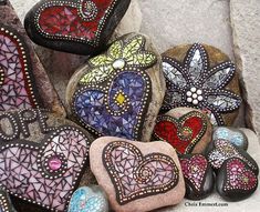 several heart shaped rocks sitting next to each other on top of a pile of rocks