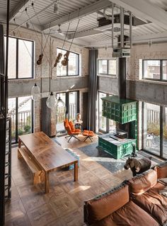 an industrial living room with exposed ceilings and wood flooring