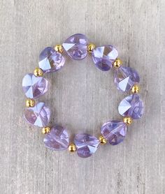 Crystal Heart Bracelet 🤍 Comes in Purple and Clear Crystal Heart beads Made with 18k filled gold beads  The cutest layering piece ✨  CARING TIPS FOR YOUR JEWELRY ⭐️Treat and store with care. ⭐️ For longevity, avoid exposing your jewelry to water. ⭐️ Avoid having direct contact with lotions, perfumes, sanitizers as these chemicals may cause discoloration of your jewelry. Gold Beaded Heart-shaped Bracelets, Gold Beaded Heart Shaped Bracelets, Heart Shaped Beaded Gold Bracelets, Gold Heart-shaped Beaded Bracelets, Heart-shaped Gold Beaded Bracelets, Heart Shaped Spacer Beads Jewelry For Gifts, Adjustable Gold Bracelets With Heart Cut, Heart-shaped Bracelets With Faceted Beads For Gifts, Heart Shaped Bracelets With Faceted Beads For Gifts