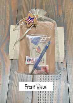 the contents of an american flag craft kit on a wooden table with text overlay