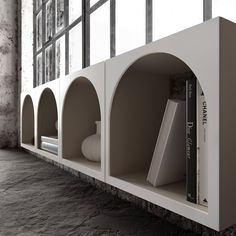 the bookshelf is made out of concrete and has two shelves on each side