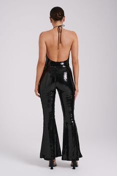 Zero disco ball required.The WILMA are a pair of sparkling wide-legged pants with a high waistline and flared hems. An invisible zipper closure at the side seam gives it a sleek, seamless silhouette. The legs transition into a flattering bootcut that complements its high, fitted waist. Lined sequinned fabrication adds a touch of comfortable glam, making these pants the perfect choice for all-night wear. Black Sequin Pants, Sequin Pants, Night Wear, Sleeveless Bodysuit, Cowl Neckline, Disco Ball, Neck Strap, High Leg, Black Bodysuit