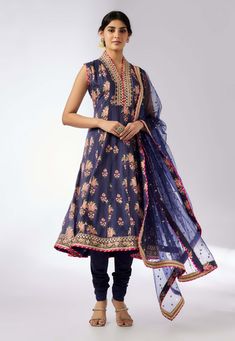 This enchanting ensemble features a floral print with intricate border embroidery. The anarkali kurta, paired with a matching dupatta adorned in sequins and gold thread, exudes elegance and charm. The plain churidar complements the set, adding a touch of feminine grace and sophistication. Perfect for any special occasion. Suits Design Latest, Navy Blue Kurta, Cotton Suit Designs, Black Anarkali, Punjabi Suit Boutique, Maharani Designer Boutique, Embroidery Suits Punjabi, Blue Kurta, Designer Punjabi Suits