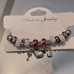 A Pandora Style Bracelet ’Key To My Heart’. 3 Charms, Lock, Key And Heart With Red And Clear Rhinestone Spacers. Heart Clasp. Not Pandora Brand Silver Rhinestone Bracelets For Valentine's Day, Silver Beaded Bracelets With Bling For Gifts, Valentine's Day Silver Bracelets With Rhinestones, Valentine's Day Silver Bracelet With Rhinestones, Red Metal Heart Bracelet Gift, Red Metal Heart Bracelet As Gift, Red Crystal Bracelet Gift, Red Crystal Bracelet For Gift, Red Metal Crystal Bracelet Gift