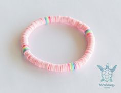 This bracelet is made of light pink and 4 areas of multicolored beads. All strung on an elastic cord. These make great gifts.  Bracelet measures 6.5" Production takes 2-3 business days. Colors might look slightly different as they vary on a different screen. May arrive separately from other items. ++ Policies ++ I do not offer refunds or exchanges unless the item arrives damaged. Photo proof of damage is required to process a return/refund. Please check the production + shipping times of items b Handmade Pink Heishi Beads Stretch Bracelet, Trendy Pink Heishi Beads Stretch Bracelet, Playful Adjustable Pink Stretch Bracelet, Playful Pink Adjustable Stretch Bracelet, Pink Heishi Beads Stretch Bracelet For Friendship, Pink Heishi Beads Friendship Bracelets For Beach, Playful Handmade Pink Stretch Bracelet, Playful Pink Heishi Beads Stretch Bracelet, Playful Pink Heishi Beaded Bracelets