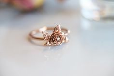 "\"ROSE\" A feminine and delicate rose flower ring with a tiny sparkle diamond. This flower ring is carved from wax by our Master Wax Carver, Somkeit then cast into 14k gold. The flowers sit on top of the band, which makes this ring stackable. You can choose between 2 flowers or 1 flower(without the flower bud). ---------------------- { n o t e } ➤ This ring is made to order, please allow 2-3 weeks for this ring to be handmade for you. Requested modifications are subject to revised production ti Rose Flower Ring, Rose Diamond, Stacked Wedding Bands, Gold Flower Ring, Gem Diamonds, Ring Hand, Rose Ring, Original Jewelry, Ring Dainty