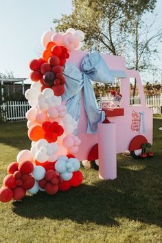 an ice cream truck decorated with balloons and streamers for a birthday or baby shower