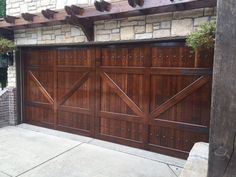 a wooden garage door is shown in front of a brick building