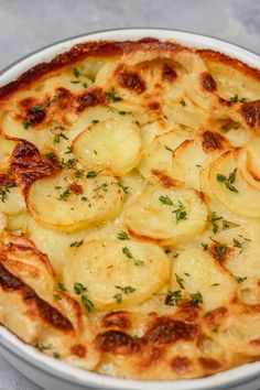 a dish with potatoes and herbs in it