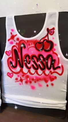 Designs by Galveston Airbrush! ♡ ✧ Our Designs on these cute White beater Tank tops are handmade with the artists' skilled Hands. The Design might look slightly different from the pictures or have small imperfections and that's okay, it's what makes them unique✧ Each design includes up to TWO names or words with up to THREE specified COLORS. SIZES: Available for ADULTS and YOUTH DESIGN PLACEMENT: All designs are airbrushed on the FRONT of our White Beater Tank top unless specified otherwise. Get more design ideas from our TikTok at @galvestonairbrush and Instagram at @Galveston_Airbrush. Follow your order process on our Insta Stories.  International orders may have an additional shipping charge. WASHING INSTRUCTIONS: º Wash it inside out in cold water º No bleach º Hang to dry º Ironed ins Spray Paint Shirt, Airbrush Clothes, Airbrushed Tanks, Personalized Football Gifts, Airbrush Shirts, Airbrush T Shirts, Airbrush Designs, 21st Birthday Photoshoot, Custom Airbrushing