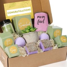 an open box with soaps, candles and other items