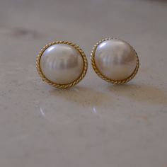 "Elegant and minimal faux pearl earrings. * Excellent vintage condition * Pierced style * Gold tone * Lightweight Measurements * 3/4\" all around" Classic Pearl Clip-on Earrings For Formal Occasions, Classic Pearl Drop Clip-on Earrings, Classic Round Pearl Clip-on Earrings, Classic Clip-on Pearl Drop Earrings, Classic Round Clip-on Earrings With Pearl Drop, Classic Round Pearl Drop Clip-on Earrings, Vintage Pearl Earrings For Formal Occasions, Classic Clip-on Pearl Earrings, Classic Round Pearl Button Earrings