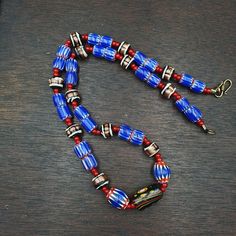 Vintage white heart Venetian Style Blue Chevron Glass Beads necklace N9-12 White Heart and Chevron Beads SIX Layer Type of Object Drawn, multi-layered glass Color BLUE, RED, White  Approximate Age Late 20th century Overall  * Condition: Good to fair.  * See picture with Size measurement tool for size comparison.  * Strand Length 22 inches (includes Lock) * Brand: East Oasis * Style: Beaded  * Type: Strand of beads Additional information: Chevron beads are the most beautiful, recogniz Oasis Style, Chevron Beads, Glass Beads Necklace, Star Mold, Object Drawing, Blue Chevron, Size Comparison, Trade Beads, Glass Color