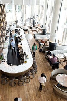 an overhead view of a restaurant with people eating at tables and standing around the bar