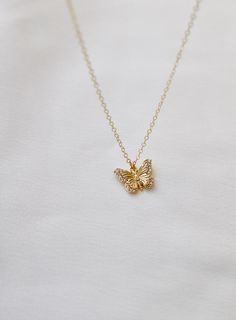 Delicate and sweet, this cubic zirconia butterfly necklace is a larger version to our Miniature CZ Butterfly Necklace . Butterflies symbolize transformation and hope which will make this a beautiful addition to your collection Materials: gold plate with cubic zirconia details Length: 18" gold chain SKU: CN1467G Materials+Care Yellow Gold Butterfly Shaped Jewelry With Cubic Zirconia, Yellow Gold Cubic Zirconia Butterfly Jewelry, Delicate Jewelry With Cubic Zirconia Butterfly Charm, Dainty Diamond Necklace With Butterfly Charm, Elegant Gold Butterfly Charm Necklace, Dainty Gold-plated Yellow Gold Butterfly Necklace, Dainty Yellow Gold Butterfly Necklace With Clavicle Chain, Dainty Butterfly Necklace For Weddings, Gold Butterfly Charm Necklace With Delicate Chain