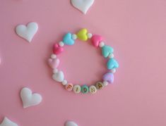 Personalized Kids Bracelet with Colorful Heart-Shaped Spacer Beads 🌈 Brighten Up Their Day with a Touch of Love 🌈 Introduce your little one to the world of fun and fashion with our Personalized Kids Bracelet, adorned with vibrant heart-shaped spacer beads. This playful accessory is perfect for adding a splash of color and joy to any outfit. 💖 Colorful Heart-Shaped Spacer Beads 💖 Each bracelet is crafted with a delightful assortment of colorful heart-shaped beads, making it a cheerful and eye Cute Bracelets For Mother's Day, Adjustable Heart Bracelet With Round Beads For Birthday, Adjustable Beaded Heart Bracelet For Birthday, Personalized Sweet Bracelets As Gift, Sweet Personalized Bracelets As Gift, Cute Heart Beads Beaded Bracelets For Valentine's Day, Cute Heart Beaded Bracelets For Valentine's Day, Cute Name Bracelet With Colorful Beads, Playful Heart Beads Jewelry For Birthday