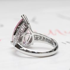 SKU : HCHB15R0318A This beautiful Sterling Silver Pear Cut 5.75 Carat Super Light Pink CZ 15.5 mm Cocktail Ring is a meticulously crafted and beautiful ring. PINK: Cherished for its emotional healing power and promoting the feeling of love and happiness, this romantic ring showcases a 5.75 carat pear cut pink with pave set band to give that extra sparkle. PEAR CUT: The elongated silhouette of this cut makes your fingers look slender and elegant. What's more, you can wear it with the point facing Super Light Pink, Feeling Of Love, Romantic Rings, Teardrop Ring, Pink Tourmaline Ring, Love And Happiness, Gold And Silver Rings, Diamond Simulant, Healing Power