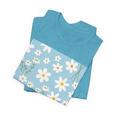 Sky Blue Daisy T - Shirt - T - Shirt - Kristine Celestine Light Blue Cotton T-shirt With Graphic Print, Light Blue Cotton Crew Neck T-shirt, Light Blue Cotton Shirt With Floral Print, Blue Relaxed Fit T-shirt For Spring, Blue Cotton T-shirt For Summer, Blue Floral Print Crew Neck T-shirt, Light Blue Crew Neck Shirt For Spring, Blue Floral Print T-shirt With Relaxed Fit, Light Blue Crew Neck Shirt For Summer