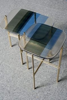 two tables sitting on top of each other in the middle of a floored area