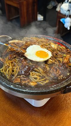 an egg on top of noodles in a bowl