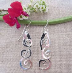 Curlicue Drops Modern Twist Silver Teardrop Jewelry, Adjustable Drop Earrings With Artistic Design, Elegant Spiral Jewelry For Gifts, Wire Wrapped Spiral Jewelry, Artistic Wire Wrapped Drop Earrings, Elegant Artistic Drop Earrings Jewelry, Modern Twist Swirl Jewelry As Gift, Modern Twist Swirl Jewelry For Gift, Elegant Dangle Jewelry With Unique Design