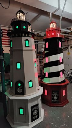 three lighthouses are lit up in different colors