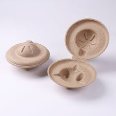 three bowls with lids are shown on a white surface