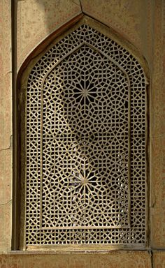 an intricately designed window on the side of a building in oman, united states