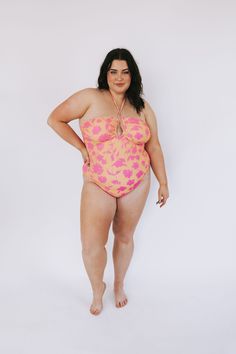 It's time to hit the waves and make a splash in our Sun Splash One Piece! With its bright yellow and pink floral pattern, tie back, and cheeky fit, this plus size swimsuit will have you looking and feeling like a queen. So be the life of the pool party and show off your curves with confidence! Details One-piece swimwear Removable padding Cheeky fit Halter top tie Fully lined Sizing Approximate measurements: SIZE LENGTH* BUST 1XL 24” 40” 2XL 25” 44" 3XL 26” 46” *Length does not include straps Fab Plus Size Maternity Swimsuit, Yellow One-piece Bodysuit For Pool, Printed Multicolor One-piece Swimsuit For Pool, Yellow Floral Print One-piece Swimwear, Pink Floral Print One-piece Swimwear, Pink Floral Pattern, Vintage Swimwear, Plus Size Swimsuits, Tie Backs