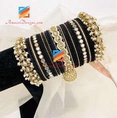 Black Velvet Sheesha Pearly Jhumki Polki Bangle Set. Order from the comfort of your hope and get them Shipped FREE from Toronto, Canada to USA, Norway, Sweden, France, Spain, Italy, Europe and every other country. 💰Price shown is for Both Hands. Explore more INDIAN BANGLES, Indian Kada, CHURA, Bridal Kada Customization - Indian Bangles can be customized with any KADA, Colour or BANGLE. This page shows just a few Latest Bangles options. Many more Indian Chura customizations can be made according Adjustable Tilla Bangle For Diwali, Heavy Adjustable Bangle For Festive Season, Traditional Black Bangle Gift, Black Bracelets For Festivals, Black Festive Bracelets For Festivals, Adjustable Bollywood Bangle For Navratri, Adjustable Bollywood Style Bangle For Navratri, Traditional Black Bracelets For Weddings, Traditional Black Bracelet For Wedding