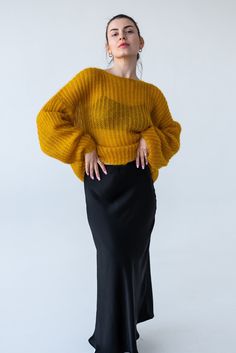 Elevate your wardrobe with our stunning Yellow Chunky Knit Mohair Sweater. Perfect for those who adore cozy, oversized fashion, this sweater combines comfort with effortless style. Features: Material: 67% super kid mohair, 30% nylon, 3% wool.  Crafted from premium mohair blend, this sweater offers a luxuriously soft touch while ensuring warmth and breathability. Design: Featuring a chunky knit pattern, this sweater boasts a relaxed, oversized fit that drapes beautifully. The cropped silhouette adds a modern twist, making it versatile for various outfit styles. Color: Deep yellow, a beautiful rich color that will be the highlight of your look. Style: The fisherman-inspired design includes a loose, easygoing knit that embodies casual chic. Perfect for layering over your favorite high-waisted Slouchy Chic Chunky Knit Sweater, Chic Oversized Cropped Sweater In Chunky Knit, Chic Oversized Chunky Knit Cropped Sweater, Chic Oversized Mohair Sweater, Oversized Yellow Sweater For Winter, Cozy Mustard Sweater For Fall, Winter Cropped Slouchy Sweater, Slouchy Cropped Sweater For Winter, Chic Yellow Sweater