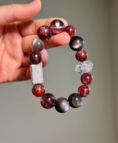 "Size: 11-14mm Material:  Hematoid Fire Quartz, Herkimer Diamond, Silver Sheen Obsidian, Peach Moonstone, 925 Sterling Silver Accessory Step into a world of natural beauty with my handcrafted gemstone bracelet!  🔥Hematoid Quartz promotes a serene mind, fostering improved thought patterns and heightened empathy. Enjoy its skincare benefits and radiate a healthy glow with regular wear. 💎Herkimer Diamond enhances spiritual awareness, achieve mental clarity, and nurture a calm and resolute consciousness. ✨Known as the \"lover's stone,\" Peach Moonstone softens the soul, fostering emotional serenity and alleviate communication-related conflicts, radiate charm, and exude a gentle aura. Embrace the magic of nature's gems and experience a blend of style and holistic well-being.  Only ONE availab Handmade Sterling Silver Crystal Bracelet For Healing, Silver Bracelets With Natural Stones For Healing, Silver Round Bead Gemstones For Gifts, Silver Bracelet With Natural Stones For Healing, Handmade Beaded Bracelets In Sterling Silver With Fusion Style, Silver Round Beaded Gemstones For Gifts, Spiritual Silver Beaded Gemstone Bracelets, Spiritual Silver Beaded Bracelets With Gemstones, Silver Beaded Bracelets With Natural Stones For Healing