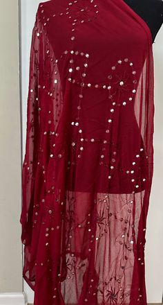 This unique Maroon Dupatta is an excellent addition to any wardrobe. Its intricate mirror detailing adds a touch of glamour to any outfit. Crafted from fine fabric, it is sure to elevate any look. Dry Clean only. Unstitched Evening Blouse Piece With Mirror Work, Semi-stitched Embellished Sequin Fabric, Elegant Red Dupatta With Mirror Work, Bohemian Embellished Georgette Dupatta, Bohemian Blouse Piece With Sheer Dupatta For Festive Occasions, Festive Bohemian Blouse With Sheer Dupatta, Festive Bollywood Sequin Fabric, Unstitched Embellished Blouse Piece For Party, Evening Sequin Fabric With Resham Embroidery