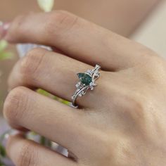 a woman's hand with a ring on it and a flower in the middle