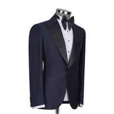 Package Includes: 1 x Jacket - 1 x Waistcoat - 1 x Pant

Upgrade your formal attire with our Dark Navy Blue Tuxedo, a blend of modern style and classic refinement. Expertly tailored for a flattering fit, this tuxedo promises both comfort and a sleek silhouette. The deep navy color adds a contemporary flair to the traditional black, ideal for weddings, galas, and any elegant affair. Constructed from high-quality fabrics, it features a satin shawl lapel and coordinated trousers, radiating luxury and elegance.

 	Fabric: 120s 
 	Lining Fabric: Silk
 	Pattern: Plain
 	Buttons: Black Fabric
 	Construction: Half Canvas
 	Seasonality: All Season
 	Jacket: Peak Lapel, 2 Flap Pockets, Single Button Closure
 	Waistcoat: Shawl Lapel 3 Buttons Closure
 	Trouser: Grey Flat front, 2 Back Pockets, Zip Cl Black Tie Tuxedo Blazer With Hidden Button Closure, Tuxedo Blazer With Hidden Button Closure For Black Tie, Blue Tuxedo Style Evening Outerwear, Evening Tuxedo With Welt Pockets And Long Sleeves, Long Sleeve Evening Tuxedo With Welt Pockets, Black Tie Tuxedo Blazer With Notch Lapel, Elegant Fitted Blue Tuxedo, Luxury Navy Formal Sport Coat, Elegant Blue Fitted Tuxedo