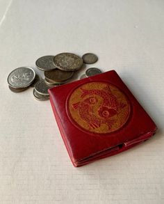 This accordion style vintage coin pouch is from the 1960s. It would make a terrific gift for the fisher or man in your life.  **NO COINS ARE INCLUDED. THEY ARE PICTURED FOR DEMONSTRATION ONLY.** Features:  * This wallet is pre-owned and has slight wear due to age and use.  * Beautiful aged red and orange with fish motif.  * Made of leather.  * Snap closure. * Approximately 3" square.  * Measure approximately 3/8" high when folded.  * Free shipping on orders over $35. Combine orders to receive free shipping.  Don't miss out on this unique vintage item! Vintage Bifold Coin Purse For Everyday Use, Vintage Bifold Coin Purse As Gift, Retro Bifold Wallet As Gift, Retro Bifold Wallet As A Gift, Vintage Handmade Coin Purse For Gift, Vintage Wallet With Coin Pocket As A Gift, Vintage Coin Purse Pouch As Gift, Vintage Coin Purse As Gift, Vintage Coin Purse With Card Slots As Gift