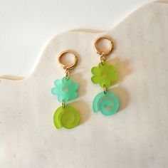 These super fun mismatched earrings are bright and playful. They come in two color-ways. Made by me in my sunny Berkeley, California apartment. I love playing with color, patten and shape to create unique earrings to brighten your day! - Gold plated studs and backings - Acrylic - 2 in x .5 in Handmade Green Flower Earrings For Everyday, Playful Hypoallergenic Dangle Earrings, Everyday Handmade Green Flower Earrings, Green Handmade Fun Earrings, Green Fun Earrings For Gifts, Green Fun Earrings For Gift, Fun Green Earrings For Gifts, Fun Green Earrings For Gifting, Trendy Green Dangle Flower Earrings