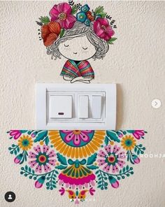 a girl with flowers in her hair is on the wall next to a light switch