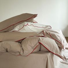 an unmade bed with sheets and pillows on it