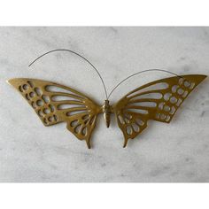 a metal butterfly sitting on top of a white counter