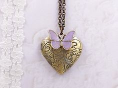 This is a sweet and romantic butterfly heart locket. It is suspended in a bronze chain along with lobster claw clasp closure.  The rustic faux pink patina heart is paired with pearly pink and gold butterfly.  The brass heart is paired with shimmer purple and gold butterfly. The locket necklace as a pendant jewelry alone is such a perfect match to fashion clothes. You can wear couples in different necklace length to create a layering style. The locket size is about 30mm x 29mm in heart shape. The Floral Boho Wedding, Butterfly Heart, Boho Birthday, Layered Fashion, Vintage Style Jewellery, Gold Butterfly, Purple Butterfly, Heart Locket, Butterfly Necklace