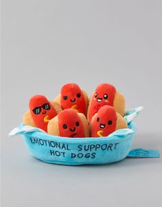 stuffed hot dogs in a blue bowl with funny faces on the front and bottom, saying'national support hot dogs '