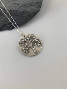 This unique Tree of Life handmade embossed round pendant has been entirely handmade using .999 fine silver. It has been cut from fine silver precious metal clay, textured, fired and oxidized. The pendant hangs from a sterling silver diamond cut cable chain. This fine silver pendant features an embossed Tree of Life image on one side of the pendant and is reversible to a tiny leaves embossed pattern on the reverse side. Pendant size: approximately 3/4 x 3/4 inches Chain length: adjustable at 16 a Layered Necklaces Boho, Moon Necklace Silver, Silver Bar Necklace, Metal Clay Jewelry, Layered Necklaces Silver, Pendant Necklace Silver, Unique Trees, Charm Necklace Silver, Silver Tree