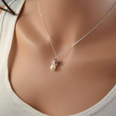 This bridal necklace is a perfect choice for a traditional wedding, where the bride wants just a touch of colour. Its pink and ivory colour combination is romantic, and reminiscent of Valentine's Day. Sterling silver cable chain extends down to a glowing freshwater drop pearl. This pearl is smooth, with beautiful luster. The cluster on top of the pearl includes tiny keishi pearls, genuine rubies and rose quartz. Very feminine, this necklace is a little splash of soft colour on your wedding day.T Pink Pearl Charm Jewelry For Wedding, Pink Pearl Pendant Jewelry For Wedding, Delicate Pink Necklace For Bridesmaid Gift, Pink Pearl Jewelry For Gifts, Pink Pearl Jewelry For Gift, Pink Pearl Jewelry Gift, Elegant Pink Bridal Necklace For Wedding, Pink Pearl Charm Jewelry Gift, Pink Elegant Bridal Necklace