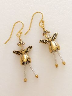 "Adorable little Christmas fairy angels made of Swarovski Crystals AB on 14k gold plated ear wires with gold plated little cone dress and delicate wings. Dangling legs are tiny iridescent glass  beads.  Sweet little fairies are about 1 3/4\" long and very lightweight.  What an adorable Christmas gift for someone special!" Bead Decorations, Sugar Skull Earrings, Angel Earrings, Gold Angel, Crystal Angels, Cute Christmas Gifts, Earrings Christmas, Christmas Fairy, Flower Skull